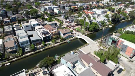 Aerial-view-flying-across-sunny-scenic-California-neighborhood-houses-and-Venice-canals
