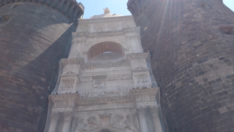 Main-entrance-Castel-Nuovo-in-Naples,-Italy,-triumphal-arch-between-two-tall-round-towers
