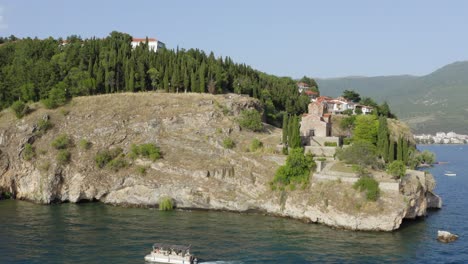 Drone-circling-around-St-John-Church-on-Lake-Ohrid-Cliff,-Summertime-in-North-Macedonia