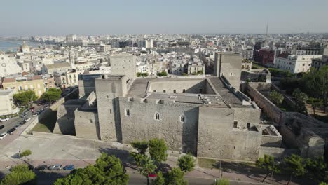 Aerial-view-of-the-city-of-Bari-and-the-exterior-of-the-castle-Castello-Svevo,-slow-rotation