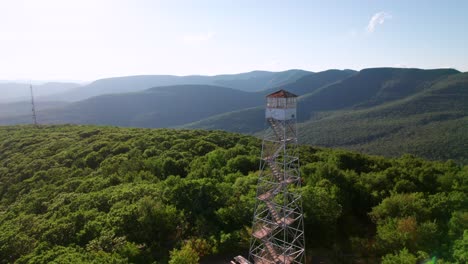 Catskill-Mountain-Range,-drone-shot-with-a-classic-old-Fire-Tower,-wilderness-forest