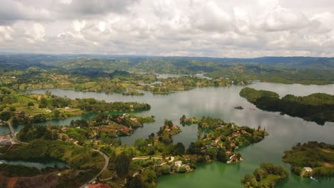 Aerial-Drone-Scenic-Landscape-Lake-of-Guatape-Rock-Piedra-Del-Penol-Colombia-Sky-Slow-Zoom-Out-View