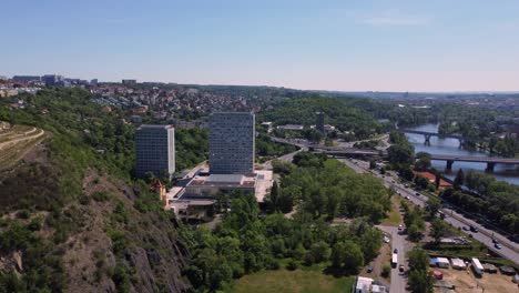 Aerial-drone-view-of-Faculty-of-Humanities-Charles-University-in-Prague,-Czech-Republic,-traffic-in-background-1