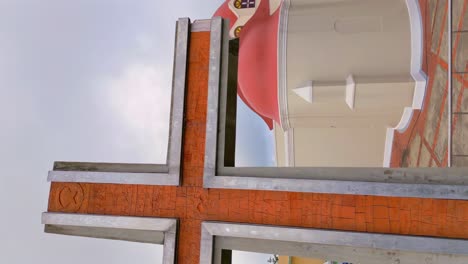 Vertical-ascend-Aerial-shot-of-cross-and-Sanctuary-of-Our-Lady-of-Mercy-on-Santo-Cerro,-Dominican-Republic