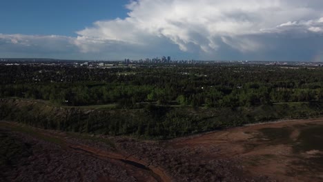 Flying-over-trees-with-downtown-view-in-the-clouds