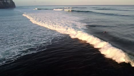 Uluwatu-bali-island-surfer-spot,-aerial-view-of-waves-in-clean-water-ocean