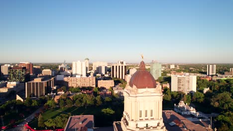 Reibungslose-Drohnenaufnahme-Der-Skyline-Der-Innenstadt-Von-Winnipeg-Mit-Dem-Goldenen-Jungen