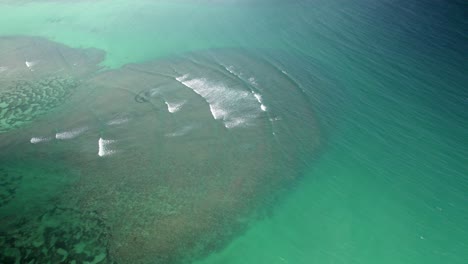 Lombok-island-aerial-view-of-huge-coral-reef-with-big-waves-in-pristine-clean-blue-ocean-water,-tropical-travel-destination-in-Asia