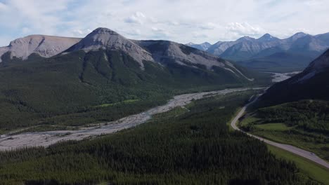 High-mountains-with-road-and-mountain-river-covered-with-forest