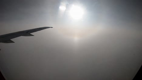 Flying-through-the-clouds-with-Sundog-time-lapse-out-window-of-plane-Northern-Manitoba-Canada