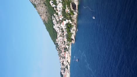 Vertikale-Aufnahme-Kroatische-Stadt-Dubrovnik-Tagsüber,-Boote-Auf-Der-Malerischen-Meereslandschaft---Drohnenaufnahme