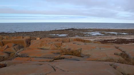 Hudson-Bay-coast-red-brown-rocky-shoreline-in-summer-near-Churchill-Manitoba-Northern-Canada