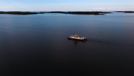 Aerial-view-around-a-transportation-ferry-in-the-archipelago-of-Ahvenanmaa,-Finland---circling,-drone-shot