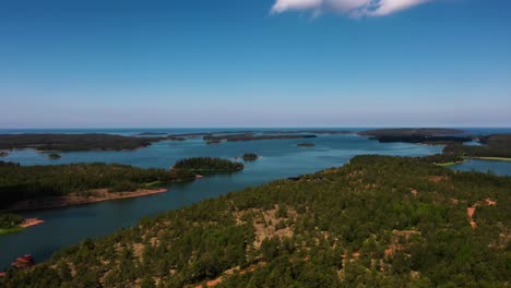 Aerial-view-over-sunlit-islands-in-Geta,-Ahvenanmaa,-summer-in-Finland---rising,-drone-shot