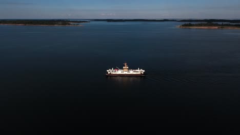 Aerial-view-away-from-a-car-ferry-in-the-archipelago-of-Aland-islands,-Finland---pull-back,-drone-shot