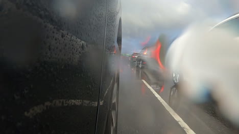 Passing-cars-on-the-right-heading-the-same-direction-with-large-green-signs-overhead