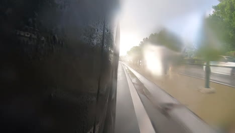 Car-on-outside-lane-moving-along-side-metal-wire-barrier-in-middle-of-road-giving-view-of-traffic-moving-in-opposite-direction