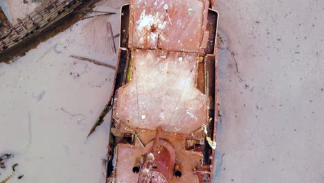 Drone-flying-vertically-over-the-entire-length-of-abandoned-ship-at-Staten-island-boat-graveyard