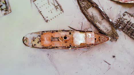 Rising-aerial-over-rusty-and-broken-ships-at-Staten-island-boat-graveyard