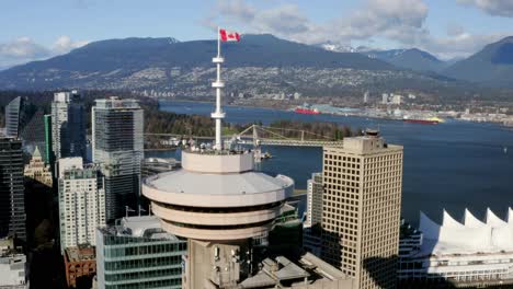 Flying-Towards-Canadian-Flag-In-Vancouver-Lookout-At-Harbour-Centre-In-Downtown-Vancouver,-Canada