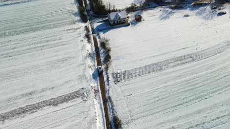 Aerial-view-of-a-van-stoping-on-a-narrow-path-in-the-middle-of-the-fields-on-a-beautiful-winter-day,-Dalmatia,-Croatia