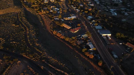 4K-Aerial-slow-pan-up-revealing-the-small-town-of-Superior-Arizona-and-beautiful-mountains-at-golden-hour-on-a-warm-evening