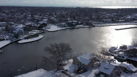 A-drone-view-high-over-Bay-Shore,-NY,-on-a-bright-day-after-a-recent-snowfall