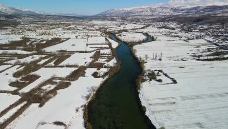 Aerial-panoramic-view-of-Celina-river-with-snow-in-a-beautiful-sunny-winter-day,-Dalmatian,-Croatia