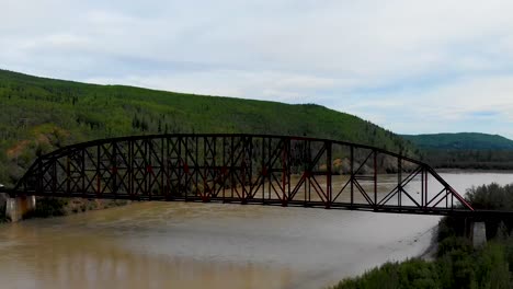 4K-Drone-Video-of-Mears-Memorial-Steel-Truss-Train-Bridge-over-the-Tanana-River-at-Nenana,-Alaska-during-Summer-Day
