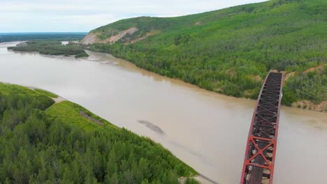 4K-Drone-Video-of-Mears-Memorial-Steel-Truss-Train-Bridge-over-the-Tanana-River-at-Nenana,-Alaska-during-Summer-Day