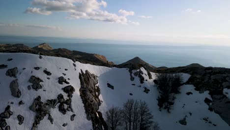 Man-hiking-peak-of-mountain-against-the-Adriatic-Sea,-Biokovo,-Croatia