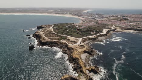 Aerial-of-rocky-peninsula-with-cliffs-in-Peniche,-Portugal