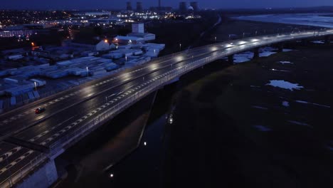 Aerial-view-modern-illuminated-quiet-highway-lanes-road-intersection-traffic-rising-tilt-left-shot
