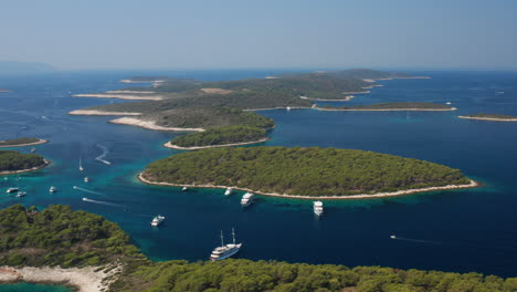 Aerial-View-Of-Boats-Moored-In-Adriatic-Sea-At-Paklinski-Islands,-Croatia---drone-shot