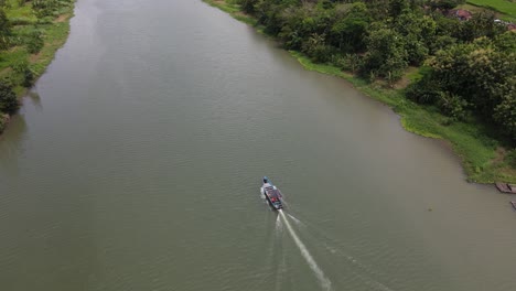 Aerial-view-of-a-traditional-boat-running-on-the-Opak-River,-Yogyakarta-with-a-beautiful-view