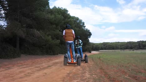 Tourists-ride-a-Segway-scooter-through-forest-and-fields