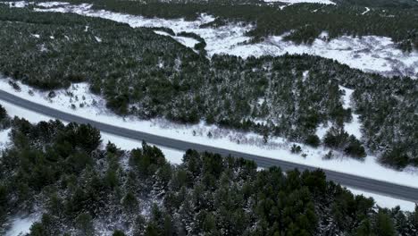 Car-Driving-In-The-Road-Along-The-Forest-In-Winter-In-South-Iceland
