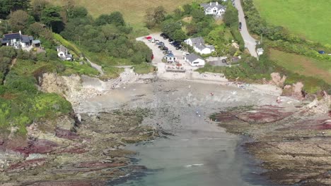 Aerial-view-pushing-into-Talland-Bay,-on-the-South-West-Coastal-path-between-the-Cornish-Town-of-Looe,-and-village-of-Polperro