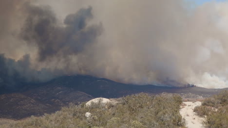 Smoke-rises-above-a-fire-area-in-Hemet,-California,-USA