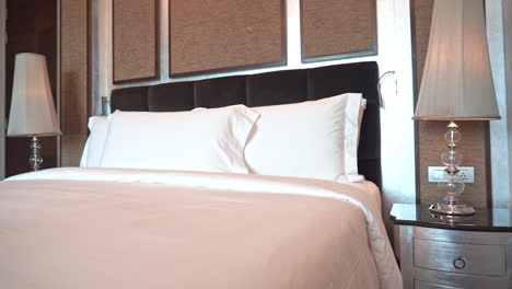 Pan-left-to-right-revealing-a-comfortable-hotel-suite-and-bed