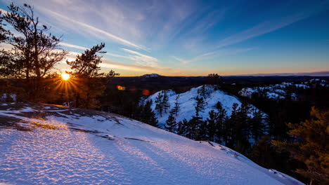 Sunset-time-lapse-over-snow-covered-hills,-Upper-Peninsula-of-Michigan-4K