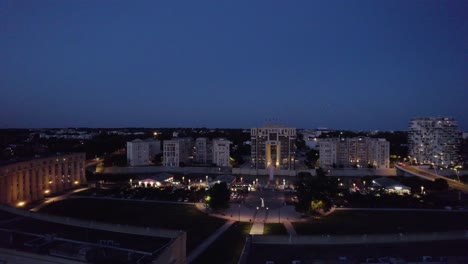 Slow-aerial-arcing-shot-of-the-beautiful-downtown-Montpellier-at-night