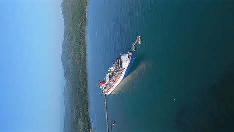 Aerial-vertical-shot-of-luxury-Cruise-Ship-docking-at-harbor-terminal-in-Puerto-Plata,-Dominican-Republic