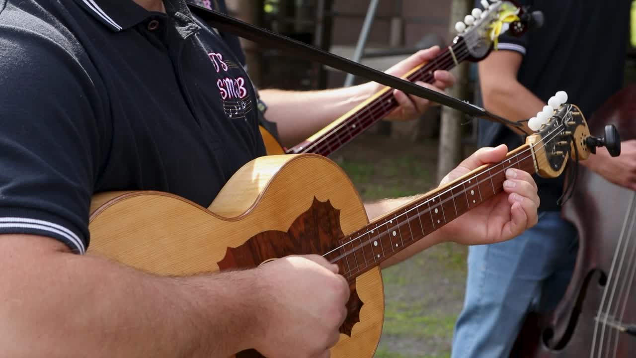 Premium stock video - Three musicians play stringed instruments in ...