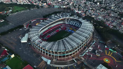 Aerial-view-away-from-the-Estadio-Azteca-stadium,-in-Mexico-City---reverse,-tilt,-drone-shot