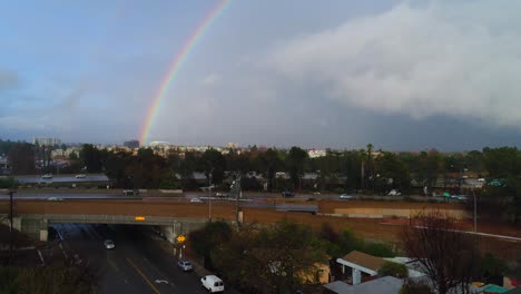 4K-Aerial-Drone-footage-of-Studio-City,-CA-with-rain,-cloudy-skies-and-a-rainbow