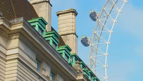 Close-up-pan-of-the-empty-and-closed-London-Eye-capsules-not-moving-against-the-County-Hall-hotel-building,-during-the-COVID-19-pandemic-lockdown-2020,-shot-on-RED-Scarlet-W-5K