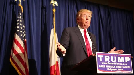 Us-Republican-Presidential-Candidate-Donald-Trump-Answers-Questions-Wisconsin-Governor-Scott-Walker-During-An-Iowa-Caucus-Campaign-Event