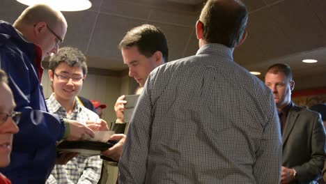 Us-Republican-Presidential-Candidate-Governor-Scott-Walker-Signs-Autographs-And-Meets-Supporters-At-A-Small-Iowa-Caucus-Campaign-Event