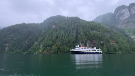 A-Cruise-Ship-Sails-Through-Alaska'S-Misty-Fjords-On-A-Snowy-Day
